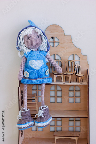 Amigurumi doll crocheted in the interior, handmade children's toys