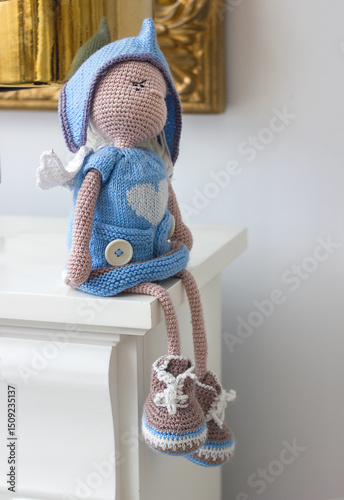 Amigurumi doll crocheted in the interior, handmade children's toys