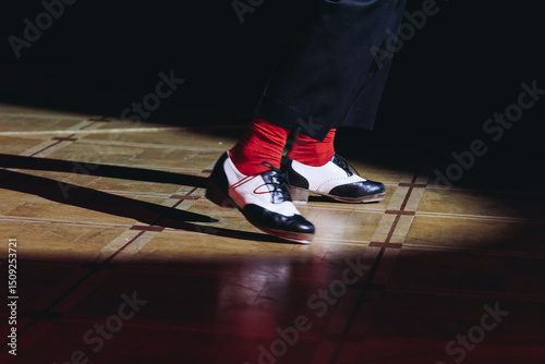 Couples dancing retro jazz swing and lindy hop, dancing suede shoes view, dancers in a ballroom club wooden floor, female and male dancing evening night, dance performance rehearsal lessons