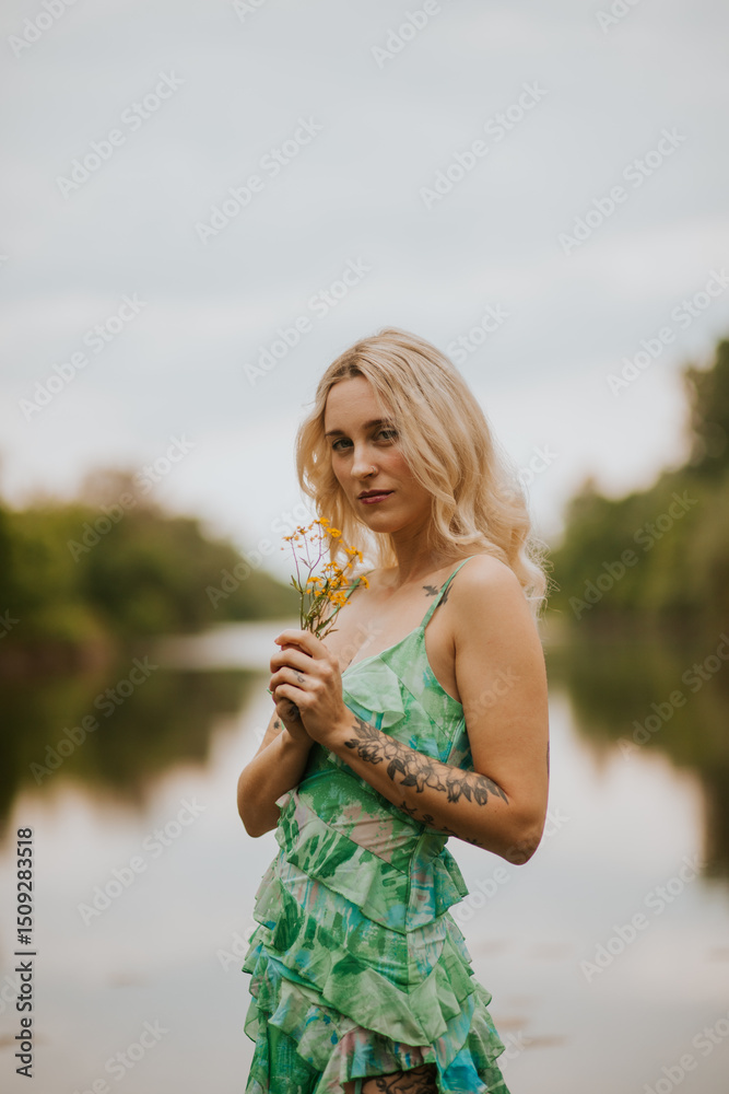 Woman in Flowing Green Dress by a Calm River in Nature Woman in Flowing Green Dress by a Calm River in Nature