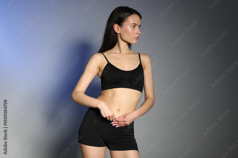 Obraz premium Beautiful woman with perfect slim body in studio