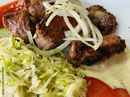 Grilled kebab with onion and cabbage.