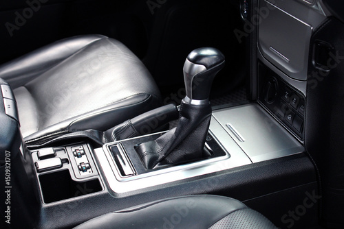 Automatic gearbox lever in New car. Close-up Automatic transmission gear shift knob, Close-up of manual gear shift of modern car. Close-up of automatic transmission lever, black leather car interior. 