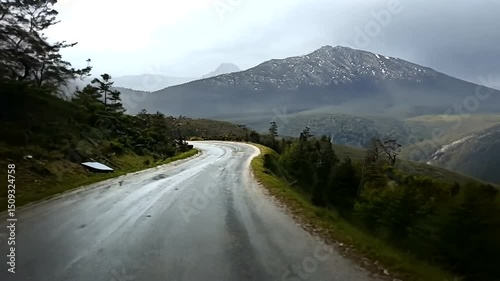 Winding road through a mountain landscape after rain