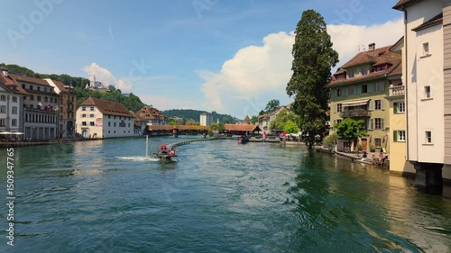 The Spreuer Bridge, a historic covered wooden footbridge, spans the Reuss River in the city of Lucerne, Switzerland. 4K UHD video.