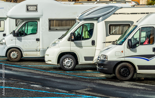 campers and motorhomes on asphatl parning, white auto caravan for  vacation travel