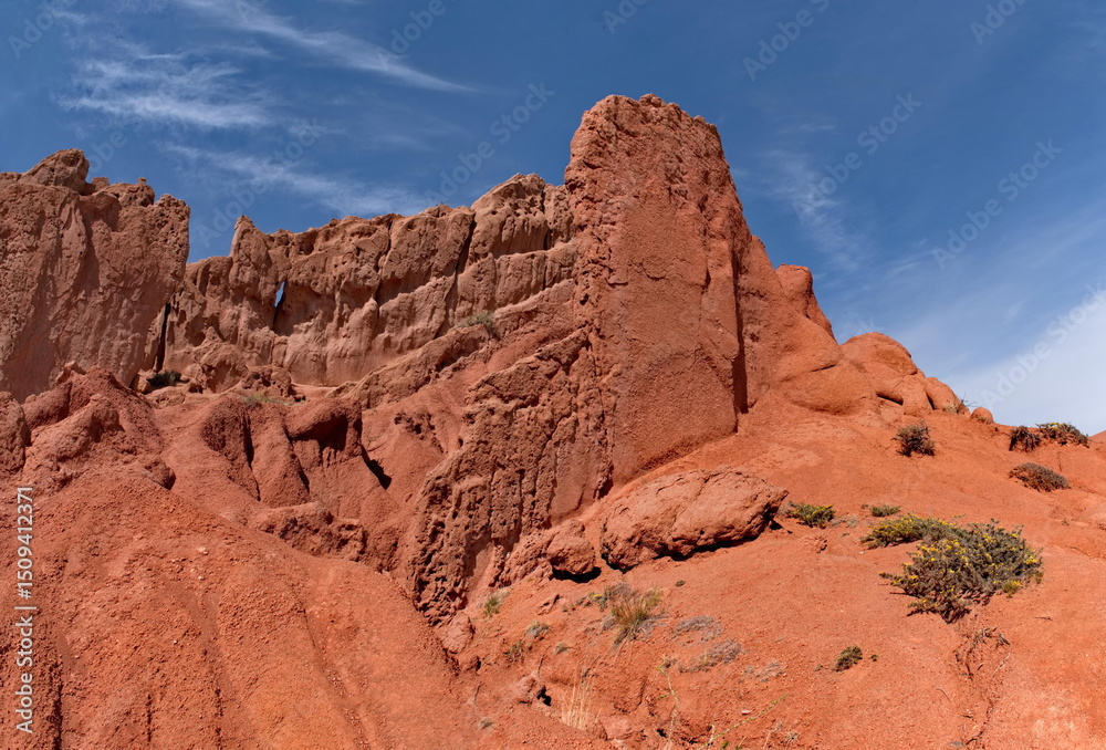 Fototapeta premium Northern Kyrgyzstan. Picturesque views of the famous Skazka Canyon, the clay mountain peaks of which have bright colors from yellow to red-brown.