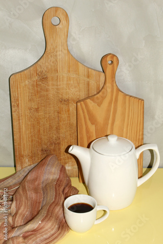 Coffee cup and coffeetop in front of cutting boards. Brazilian coffee. photo