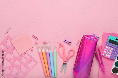 Composition with pencil case and school stationery on pink background