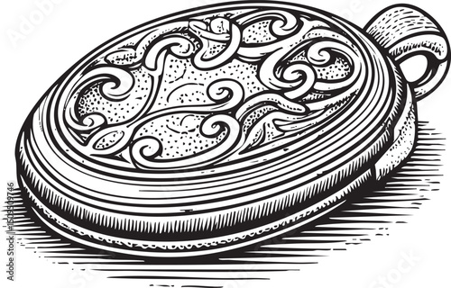 decorative oval-shaped metal locket rests on a dark surface.
