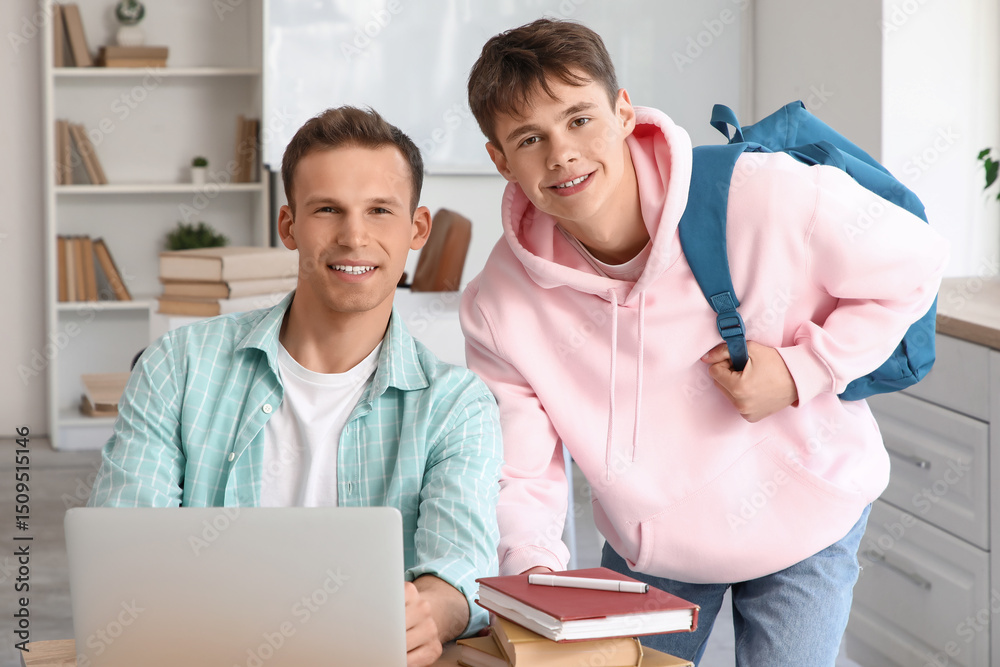 Fototapeta premium Male students studying with laptop at university