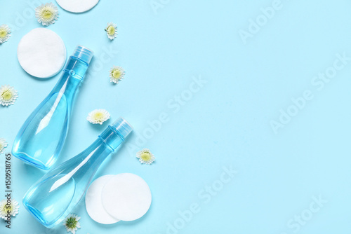 Wallpaper Mural Bottles of micellar water, cotton pads and flowers on blue background Torontodigital.ca