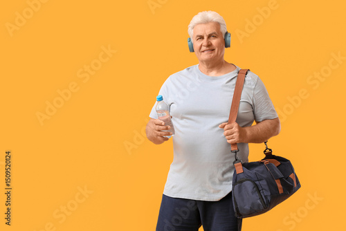 Senior man in headphones wi...