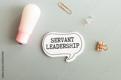 Servant Leadership write on paperwork isolated on Wooden Table