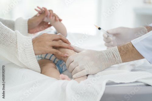 Fotografie Asian loving mother comforts her three-month-old, as a male doctor administers essential childhood vaccinations, ensuring the baby's healthy future in a calm, professional setting