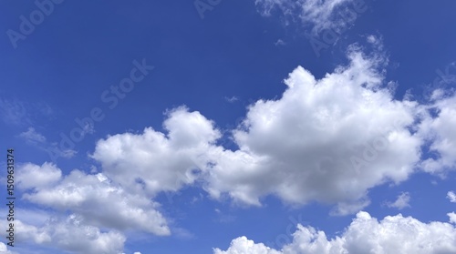 Azure sky adorned with puffy clouds