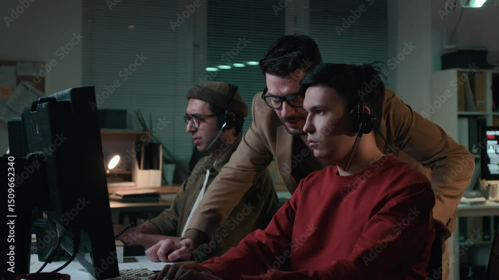 Medium side shot of joyous Caucasian male manager walking around criminal call center office, observing workers chatting to victims promoting fake investment scheme, encouraging on aggressive approach Medium side shot of joyous Caucasian male manager walking around criminal call center office, observing workers chatting to victims promoting fake investment scheme, encouraging on aggressive approach