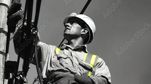 Dedicated lineman connecting cables, working diligently, power transmission and energy worker