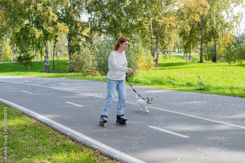 Wallpaper Mural Caucasian woman roller skating with her jack russell terrier dog in park.  Torontodigital.ca