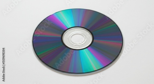 Shiny compact disc isolated on white background reflecting light in a colorful spectrum 