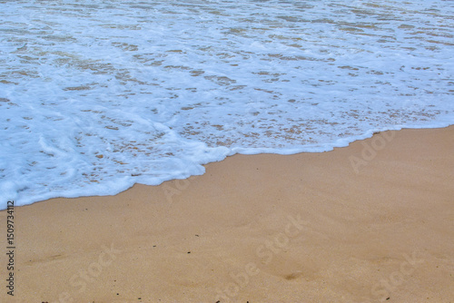 Fototapeta Naklejka Na Ścianę i Meble -  bubbble white waves on the sand