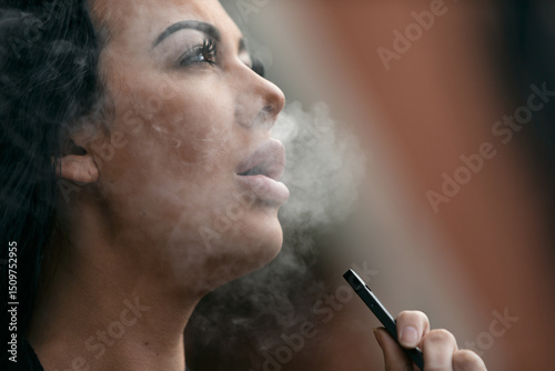 Adult Female Vaping With An E-Cigarette