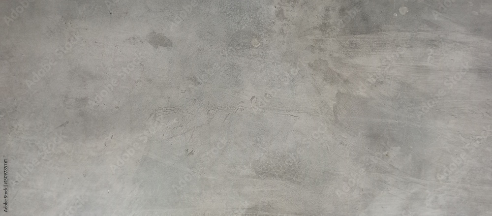 Naklejka premium Distressed Gray Concrete Wall with Subtle Patches and Stains