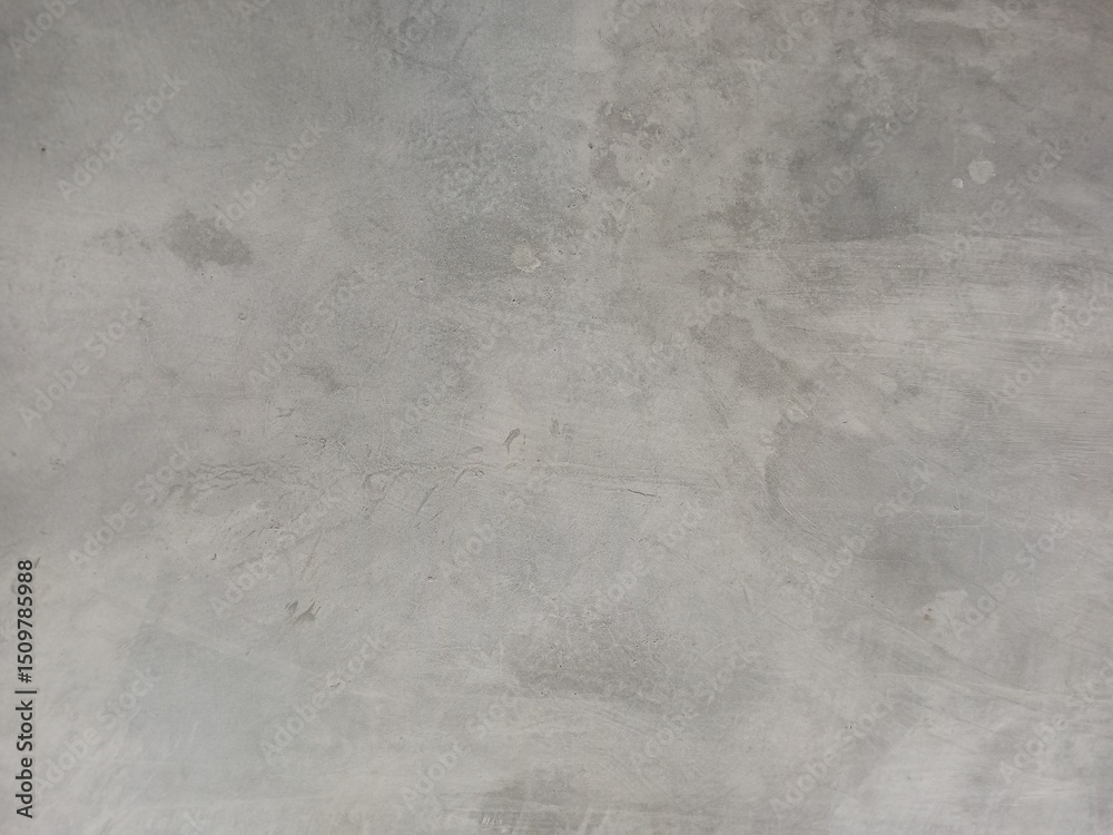 Naklejka premium Distressed Gray Concrete Wall with Subtle Patches and Stains