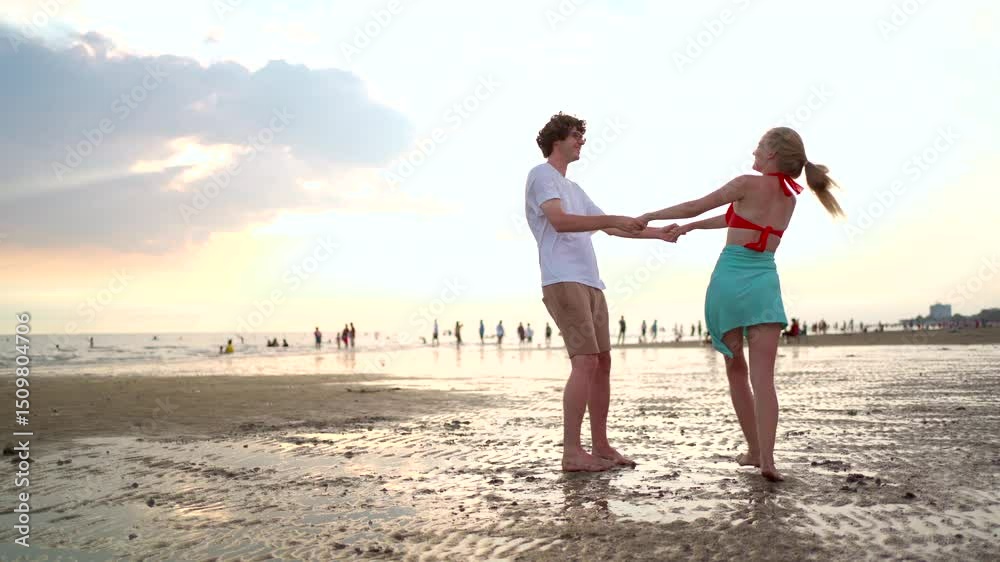 Romantic white Western couple walking and playfully teasing each other along the beach at sunset. Romantic white Western couple walking and playfully teasing each other along the beach at sunset.