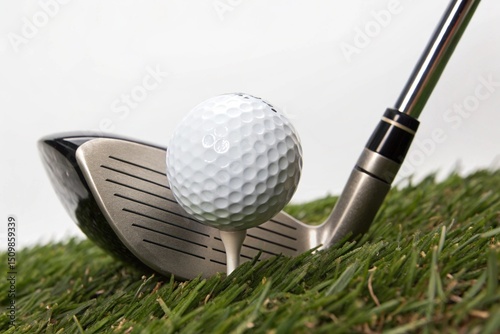 A golf ball is resting on a golf club's tee