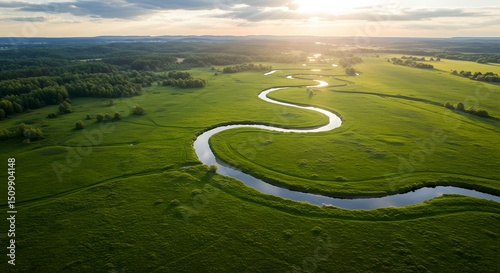 Wallpaper Mural Serpentine River Winding Through Lush Green Meadows at Sunset An Aerial View of Nature's Beauty Torontodigital.ca