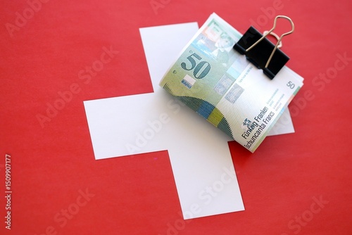 Swiss franc banknotes and flag. The francs money bills lies on flag in big amount photo