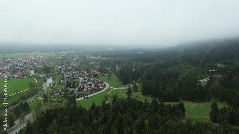 Fototapeta premium Colorful houses below dramatic alpine peaks