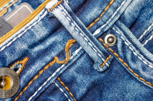 Close-up of denim belt loop on blue jeans