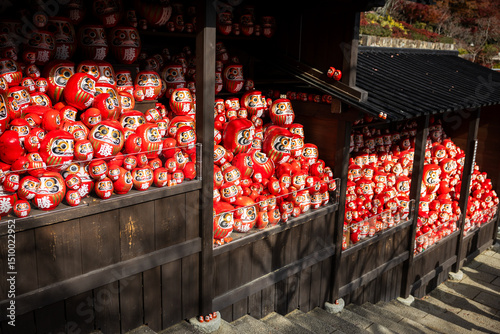 Osaka, Japan - December 2024: Scenic view of Katsuoji Temple in Minoh during peak autumn season. Beautifully framed by vibrant red and orange maple leaves, reflecting the serene atmosphere of autumn.