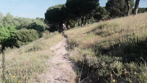 Senior Man Hiking on a Nature Trail Through Scenic Greenery