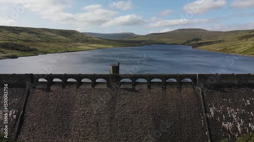 Aerial shot of the vast, scenic Scar House Reservoir dam with the sweeping lake beyond, highlighting the dam’s architecture and the contrast between man-made structures and the natural landscape photo