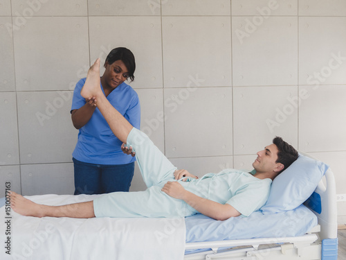 Physical therapist woman nurse black people with patient caucasian man carer  two people sit and sleep talk helping support give advice holding relax massage on leg body in room hospital clinic.