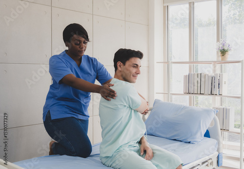 Patient caucasian man with woman nurse black people carer physical therapist two person sitting talk helping support give advice and holding relax massage on back body in room service hospital clinic