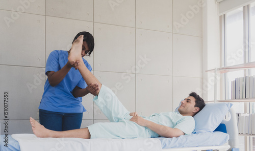 Physical therapist woman nurse black people with patient caucasian man carer two people stand and sleep talk helping support give advice holding relax massage on leg body in room hospital clinic.