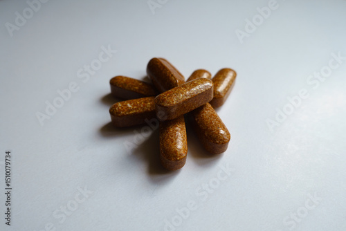 Closeup of handful of brown caplets of iron dietary supplement