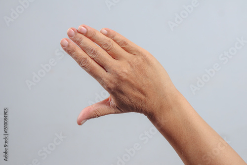 Side view hand forming L shape with thumb and fingers as symbol or sign language