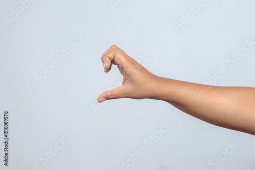 Hand shaped like holding invisible object, forming semicircle grip gesture photo