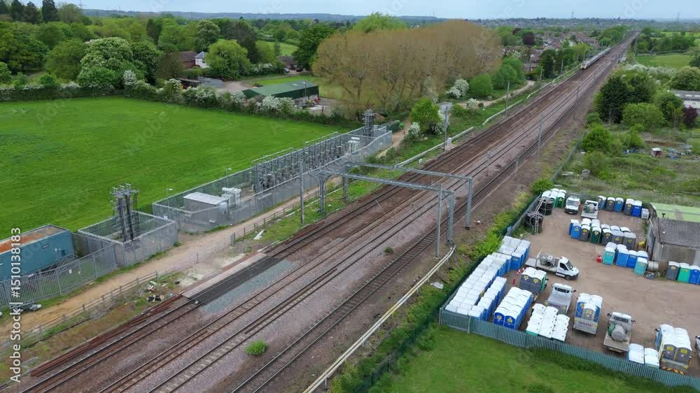 Close Aerial Drone Shot of Train Passing Substation in Hitchin, UK Close Aerial Drone Shot of Train Passing Substation in Hitchin, UK