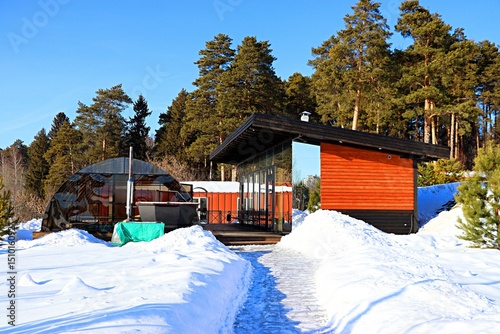 Winter landscape, tourist houses in the forest on a hillside