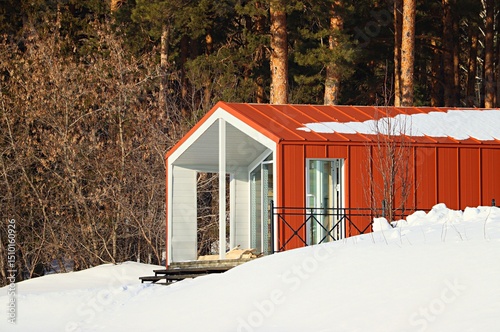Winter landscape, tourist houses in the forest on a hillside