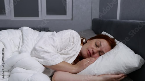 red haired middle aged woman trying to sleep, insomnia and sleep problems, stress at work