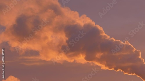 Thick, swirling smoke flows amid warm hues at dusk, evoking an intense