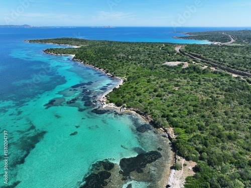Fototapeta Naklejka Na Ścianę i Meble -  Aerial view of Marinella beach and harbour, white sand beach bathed by a beautiful turquoise water. Marinella Beach, Porto Rotondo, Costa Smeralda, Olbia, north east coast of Sardinia, Italy
