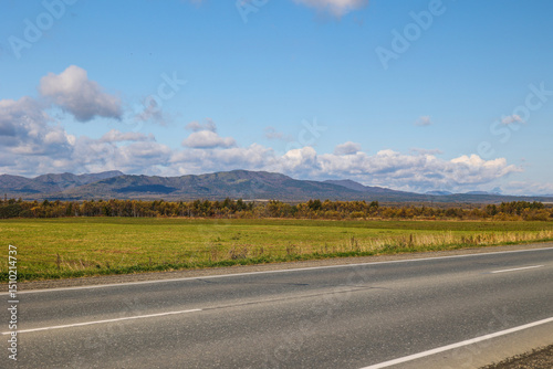 Asphalt road in mountainous area. Sunny mountain landscape